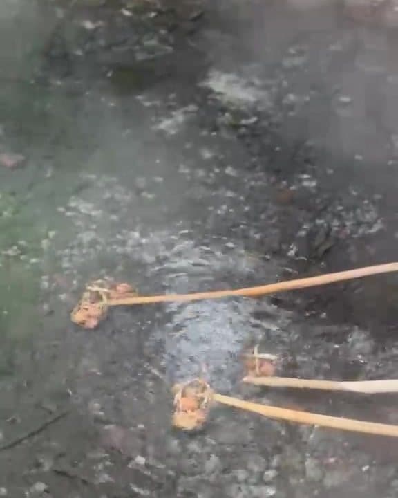 Eggs in bamboo baskets cooking in the hot spring
